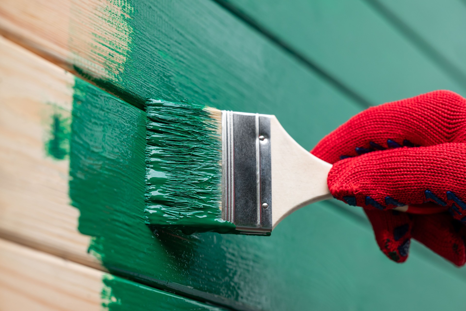 Painting outdoor house wall with a brush